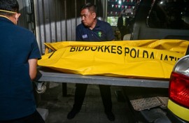 Police officials transfer the remains of a student, killed in the collapse at a boarding school on Indonesia's Java island