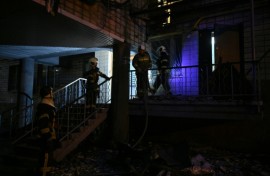 Ukrainian firefighters work in a residential building, damaged during the massive Russian drone and missile strikes