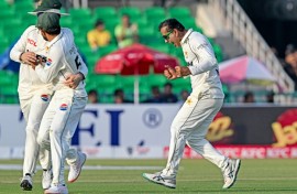 Pakistan's Noman Ali (R) celebrates after taking the wicket of South Africa's captain Aiden Markram on day three