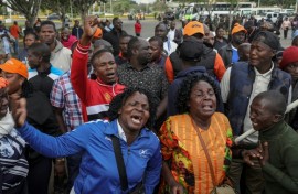 Supporters and mourners of Kenyan opposition leader Raila Odinga react at the Jomo Kenyatta International Airport (JKIA) in Nairobi