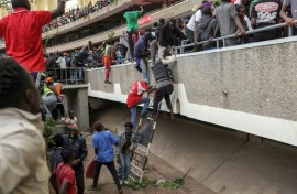 Kenyans fled when security forces fired into the stadium where they gathered to view Odinga's coffin