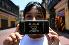 Peruvian law graduate Rosalinda,26, of the Gen Z movement, shows the "One Piece" manga flag on her mobile phone, signifying a demand for deep reforms amid growing insecurity and a decade of political instability