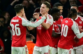 Arsenal striker Viktor Gyokeres (C) celebrates with team-mates at the Emirates Stadium after scoring their fourth goal during a 4-0 win over Atletico Madrid in the Champions League