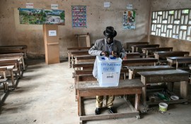 A voter casting his ballot at a polling station in Abidjan