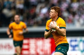 Australia's Tane Edmed runs with the ball against Japan