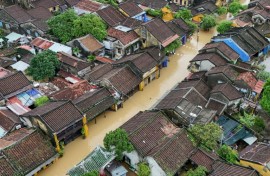 Heavy rains in central Vietnam pushed a major river to a 60-year high and flooded the streets of Hoi An