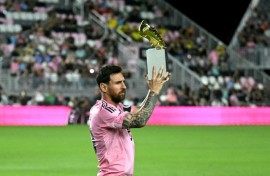 Lionel Messi poses with the MLS Golden Boot trophy after scoring 29 times in 28 games in the regular season