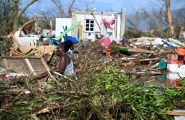 A man stands next to a damaged house after the passage of Hurricane Melissa in Boca de Dos Rios village, Santiago de Cuba province, Cuba