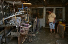 Floodwaters described as unprecedented rushed through Cebu, sweeping away cars, riverside shanties and even massive shipping containers