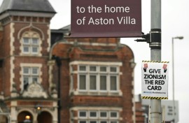 A poster that reads 'Give Zionism the red card' is seen on a lamp post near Villa Park in Birmingham ahead of the Europa League match between Maccabi Tel Aviv and Aston Villa