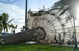 People rest near a structure, damaged by typhoon Kalmaegi, in the Quy Nhon area of Gia Lai province, central Vietnam