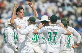 South Africa's Marco Jansen celebrates with teammates after taking the wicket of India's KL Rahul