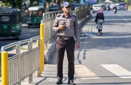 A Bangladesh police officer wears the new grey and brown uniform in Dhaka, but critics doubt whether the change in colours will mend the force's shattered reputation