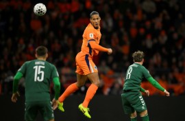 Heading to the World Cup: Virgil van Dijk of the Netherlands out jumps two Lithuanians