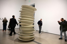 Visitors look at "No title (stacked plates, white)," a 1993 large-scale art work by Robert Therrien, during the exhibition "Robert Therrien: This is a Story" at The Broad in Los Angeles, California