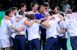 Flavio Cobolli (C) is mobbed by his team-mates after sealing another Davis Cup triumph for Italy