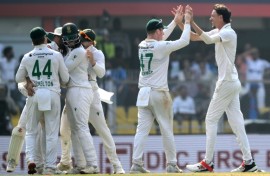 South Africa's Marco Jansen (R) celebrates with teammates after taking the wicket of India's Nitish Kumar Reddy