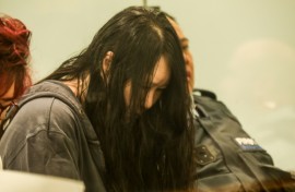 Flanked by security guards and a translator, 45-year-old Hakyung Lee showed little reaction as the sentence was handed down