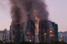 Al least four people were killed when a fire engulfed several high-rise blocks in a residential estate in Hong Kong