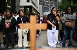 Filipinas in Hong Kong take part in a prayer service for victims of the Tai Po fire. At least 10 of the 146 killed were migrant workers
