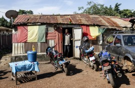 A man stands at the door of a makeshift cafe in Conakry's Yattaya T6 suburb, where young people who spoke to AFP had gathered