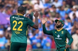 South Africa's Lungi Ngidi (L) celebrates with captain Temba Bavuma after taking the wicket of India's Virat Kohli