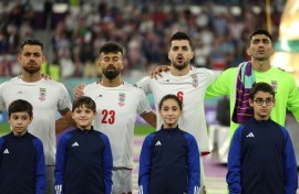 Iranian players sing the national anthem before their World Cup match against the USA at the 2022 tournament in Qatar