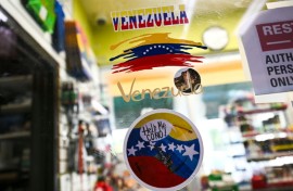 Venezuela-themed stickers decorate a window in the Doral food mart