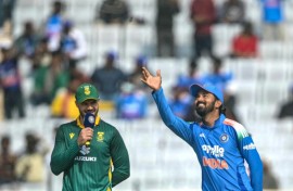 India's captain KL Rahul (R) tosses the coin as his South African counterpart Aiden Markram watches before the start of the first one-day international Ranchi. India have defied million-to-one odds to lose 20 tosses in a row