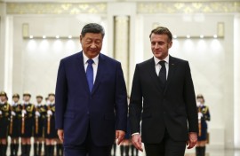China's President Xi Jinping (L) and France's President Emmanuel Macron attend a welcome ceremony at the Great Hall of the People in Beijing on December 4, 2025