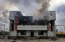 Smoke rises from a heavily damaged train station building in the town of Fastiv in Ukraine's Kyiv region after an air attack