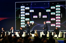 FIFA president Gianni Infantino (center-L) speaks on stage on Saturday as the match schedule for the 2026 World Cup is revealed