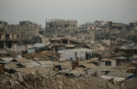 Displaced Palestinians set up their tents surrounded by rubble from buildings destroyed by the Israeli military in central Gaza
