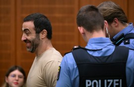 The alleged ringleader, an Armenian national partially identified as Vardges I., is led into the courtroom