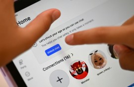 10-year-old Bianca Navarro tries to unlock a social media site after receiving an age verification message at her home in western Sydney