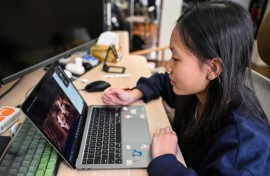 Estella, 14, a homeschooled student, does a Spanish class from her bedroom in Shanghai