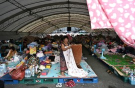 Displaced residents rest at an evacuation centre at Chang International Circuit in the Thai border province of Buriram