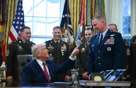 US President Donald Trump speaks with military officers at the White House