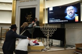 Many mourners were overcome with grief as they saw the black casket carrying rabbi Eli Schlanger.