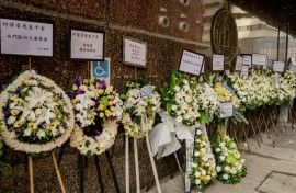 Floral tributes placed in mourning at the funeral for firefighter Ho Wai-ho, who died in the deadly fire at the Wang Fuk Court