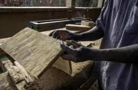A man works as a carpenter in a workshop dedicated to training former child soldiers in the Democratic Republic of Congo