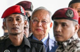 Former Malaysian prime minister Najib Razak (C) was found guilty in the 1MDB financial scandal