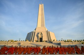 Cambodian Buddhist monks participate in a prayer for peace at the Win-Win monument