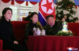 This picture taken on December 31, 2025 and released by North Korea's official Korean Central News Agency (KCNA) via KNS on January 1, 2026 shows North Korean leader Kim Jong Un, his daughter Kim Ju Ae (C) and wife Ri Sol Ju (L) watching a New Year's celebration performance at the May Day Stadium in Pyongyang