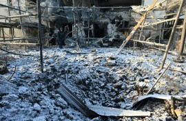 A Ukrainian rescuer works at the site of an air strike in Kharkiv