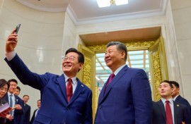 South Korea's President Lee Jae Myung (L) takes a selfie with China's President Xi Jinping (R) after a dinner at the Great Hall of the People in Beijing on January 5, 2026