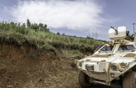 A UN peacekeeping mission armoured vehicle patrols a road in Ituri province