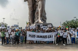 Supporters of Benin's President Patrice Talon waved banners reading 'Never Again' after a failed coup attempt in December