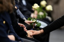 Attendees at the ceremony in Martigny held white roses in memory of the victims of the Crans-Montana fire tragedy