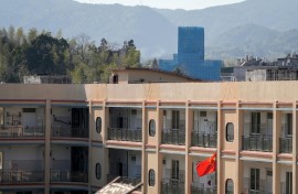 The Yayang church (at rear) is seen covered in scaffolding in Yayang township, Wenzhou city